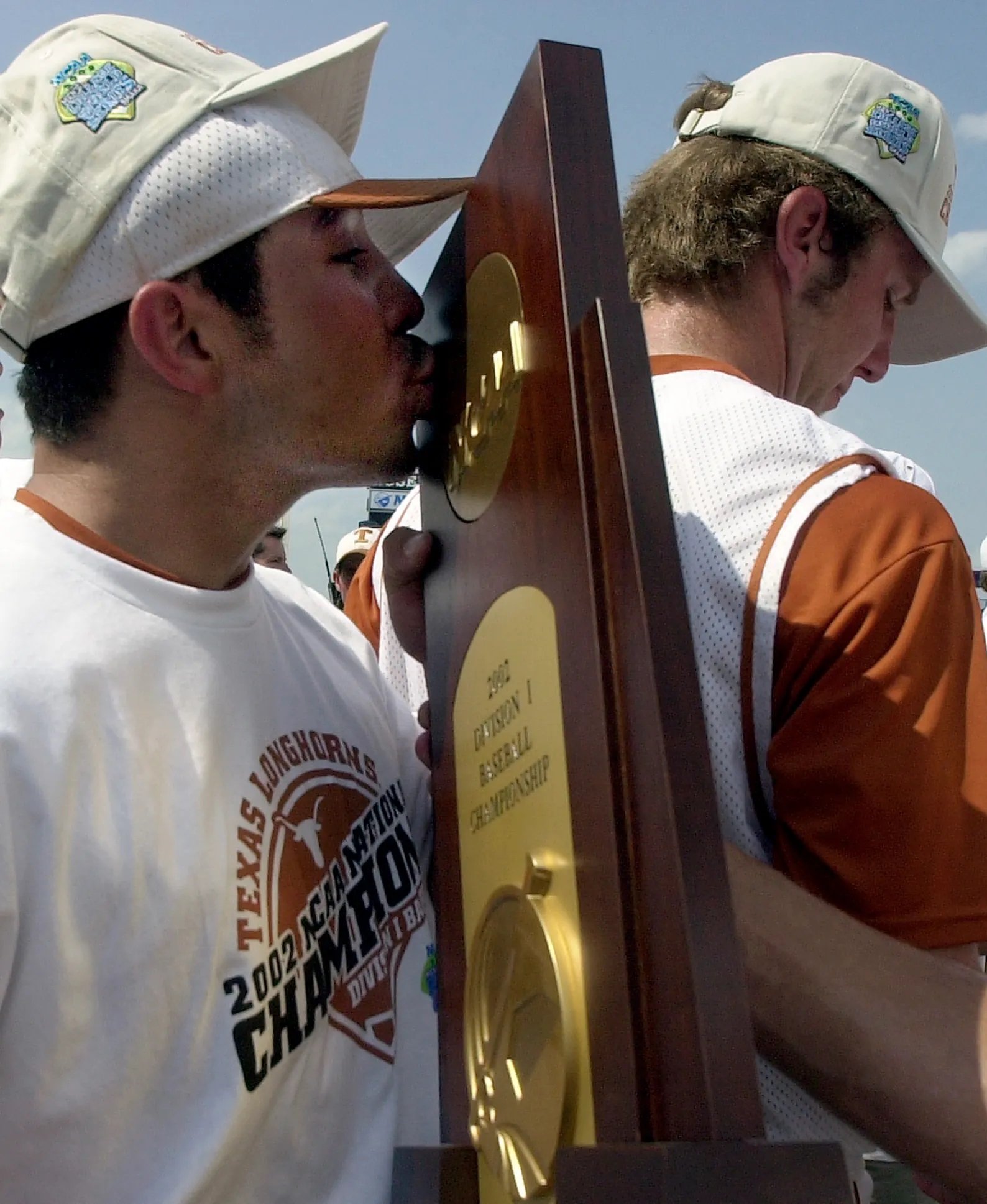 2002  Omar Quintanilla enjoys the CWS championship trophy 2