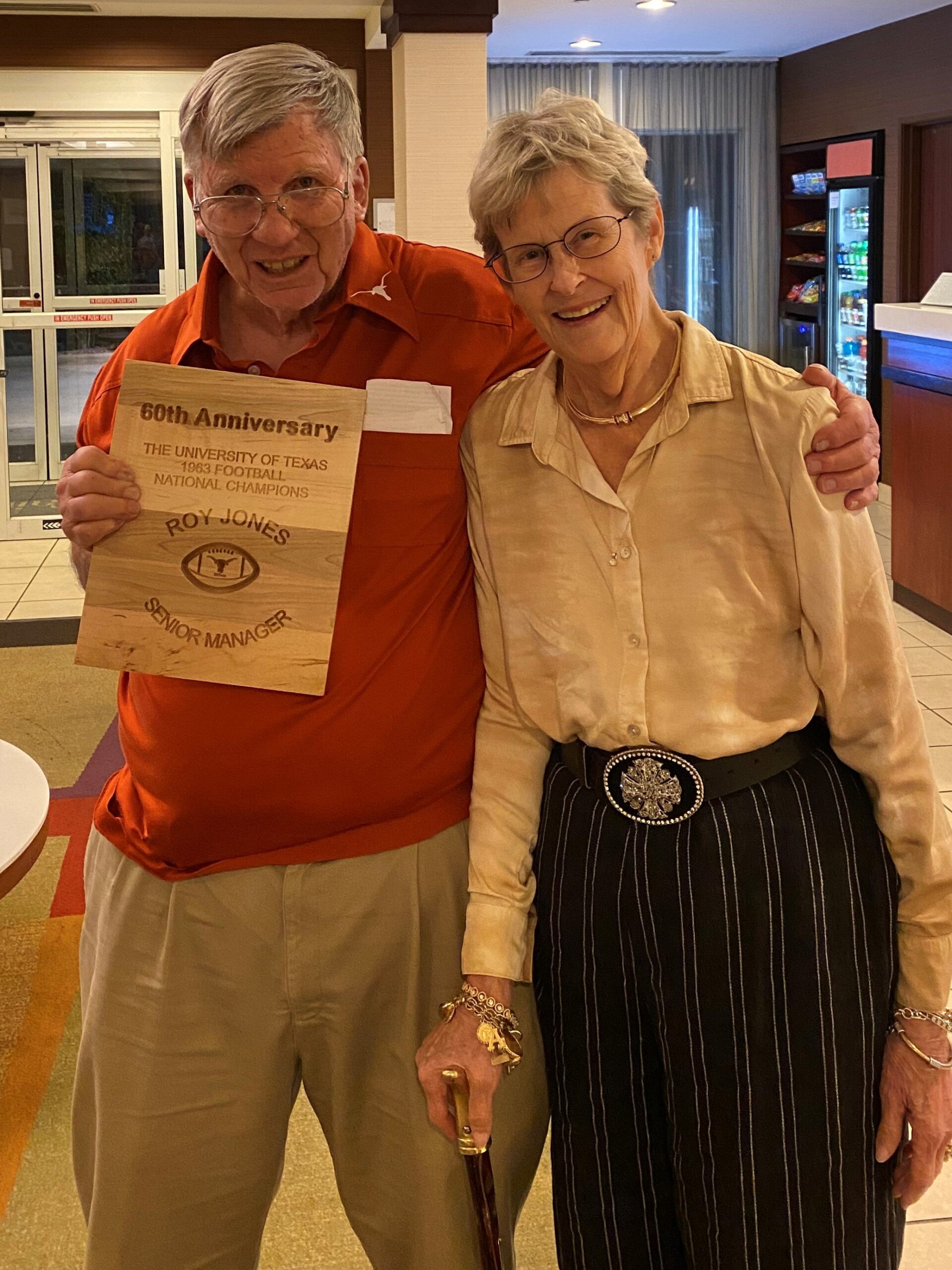 Senior manager Roy Jones and wife Trish show off his wooden plaque