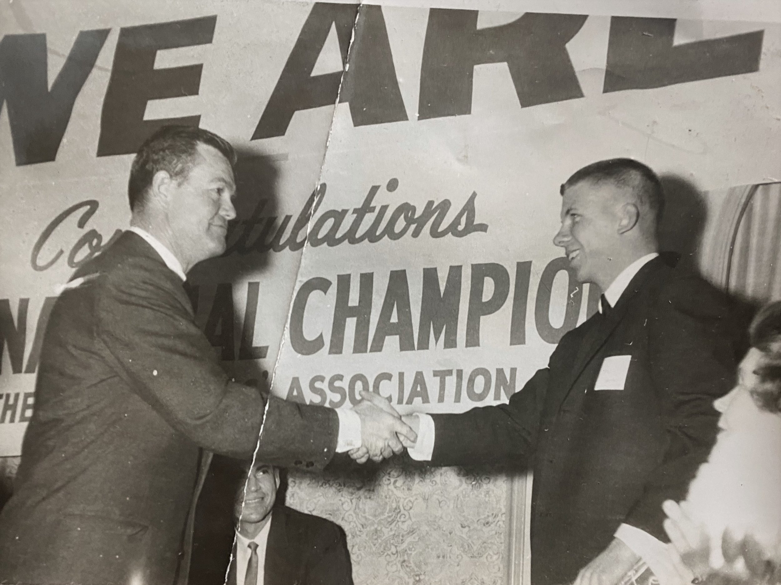 Roy is with Coach Royal at the  banquet after the 1964 Cotton Bowl  The banner in the background said  We are ready  the response to the Navy coach.JPG