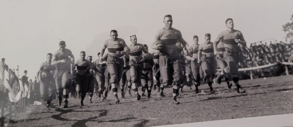 1951 Horns run on to the the New Aggies stadium. Dittmar leads the way